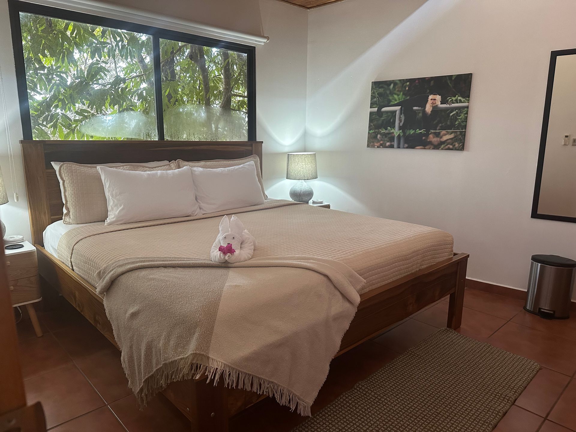 A bedroom with a king size bed and a large window