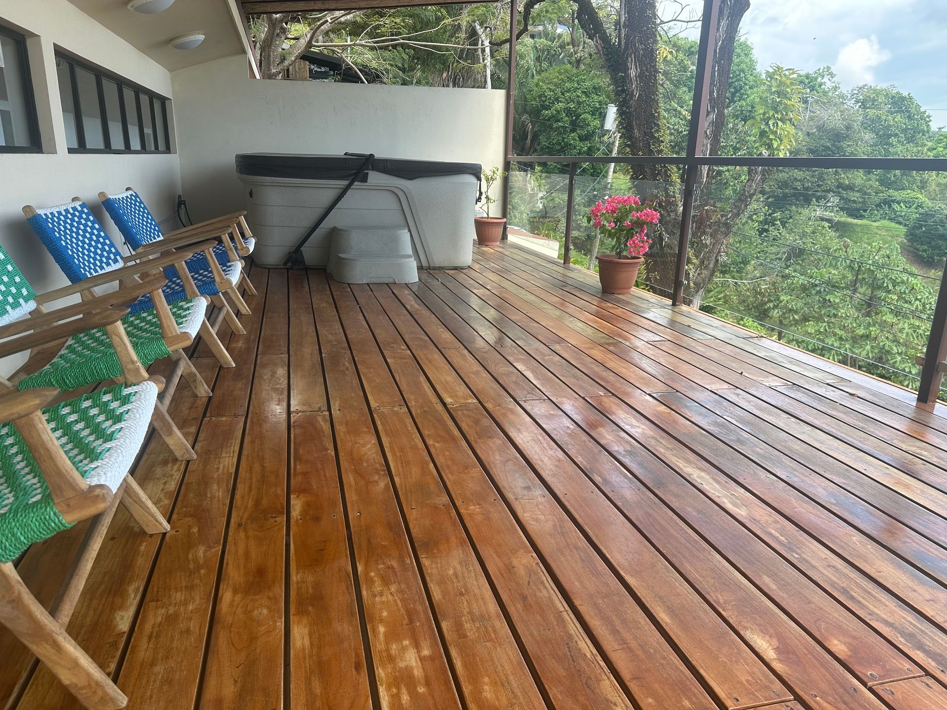 A wooden deck with chairs and a hot tub on it