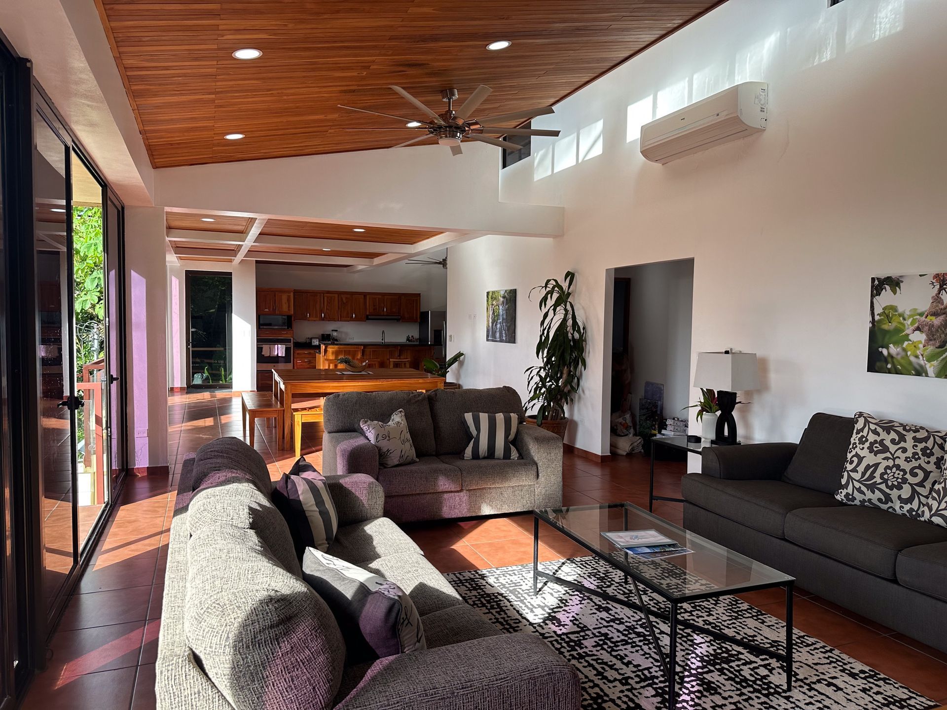 A living room filled with furniture and a ceiling fan.