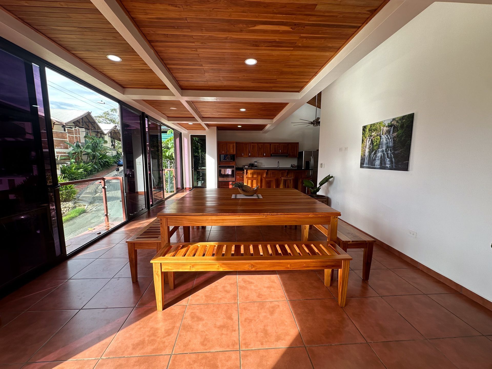 A large room with a wooden table and benches in it.