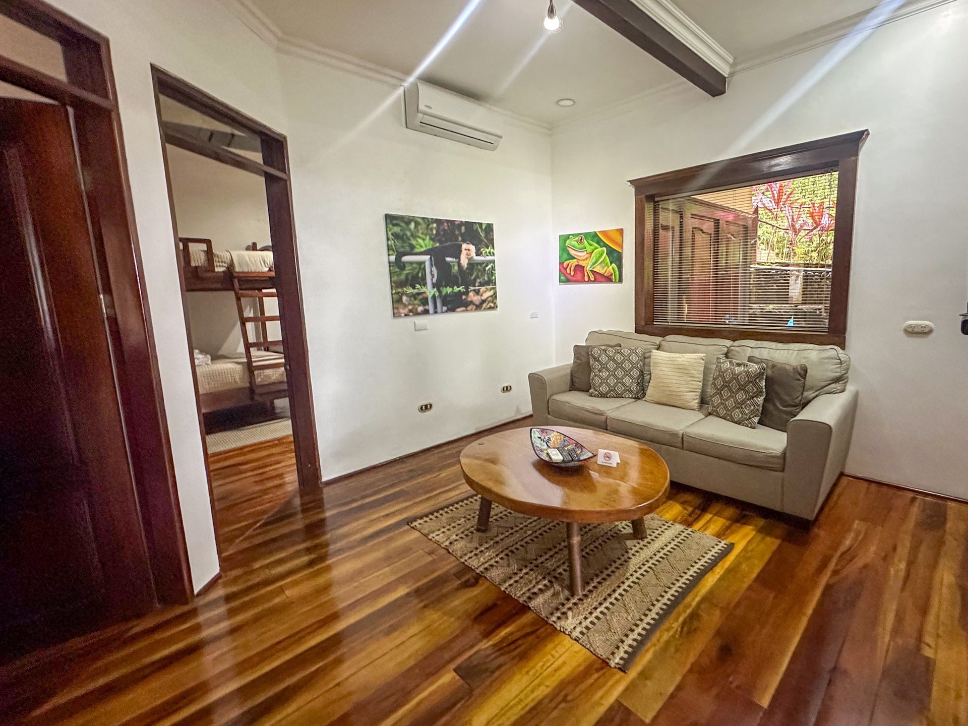 A living room with a couch , coffee table and bunk beds.