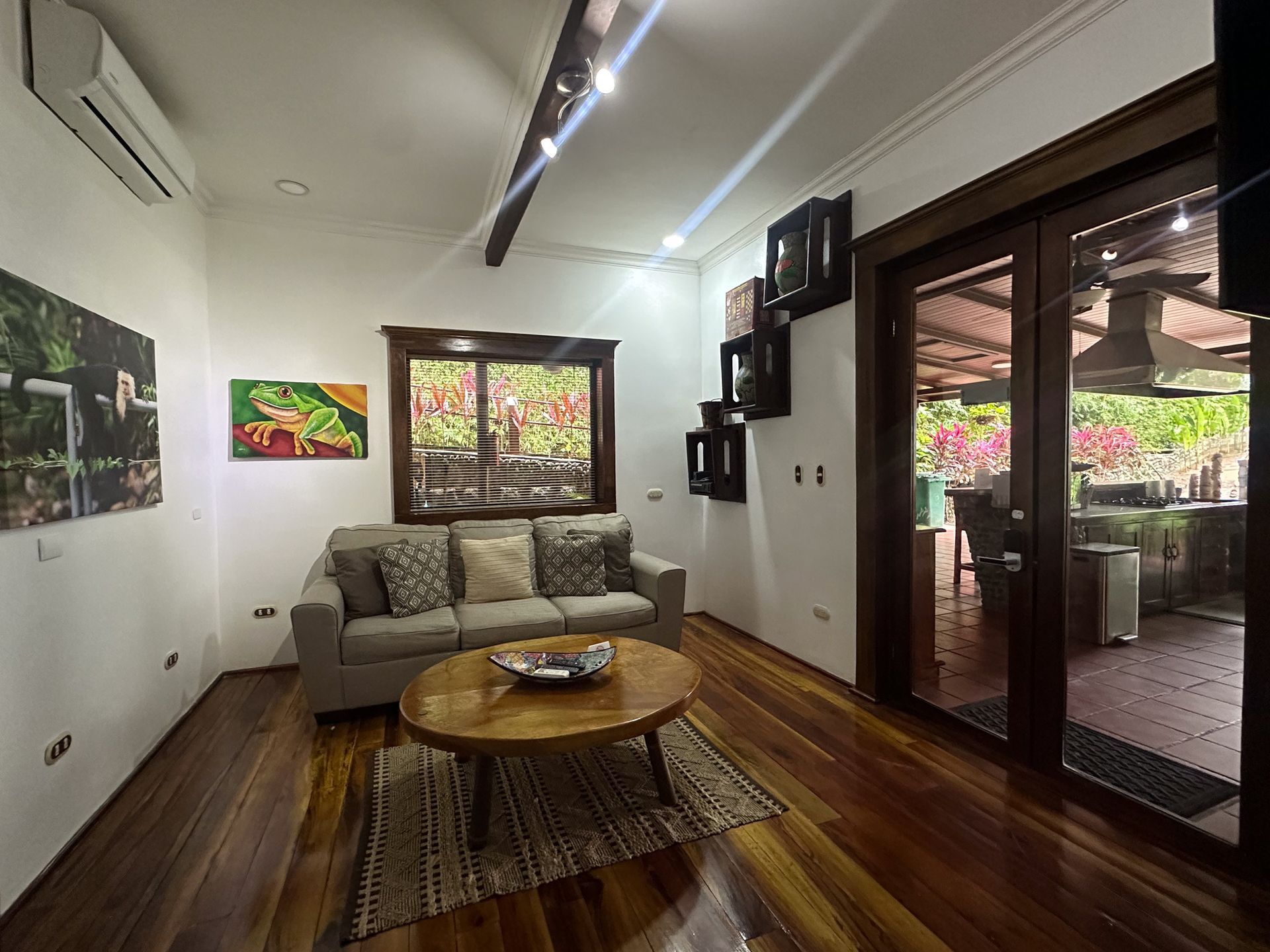 A living room with a couch , coffee table , and sliding glass doors.