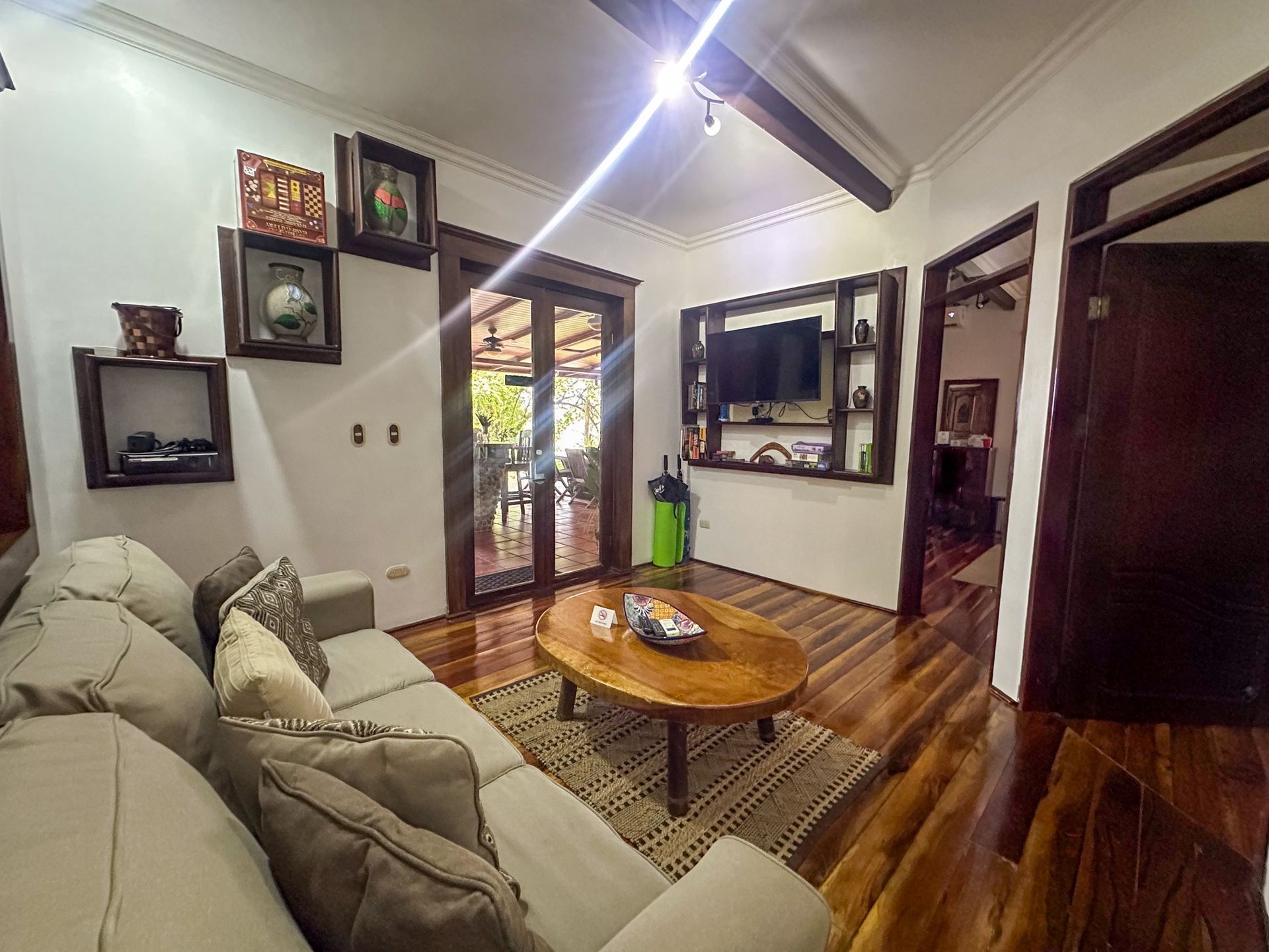 A living room with a couch , coffee table , and television.