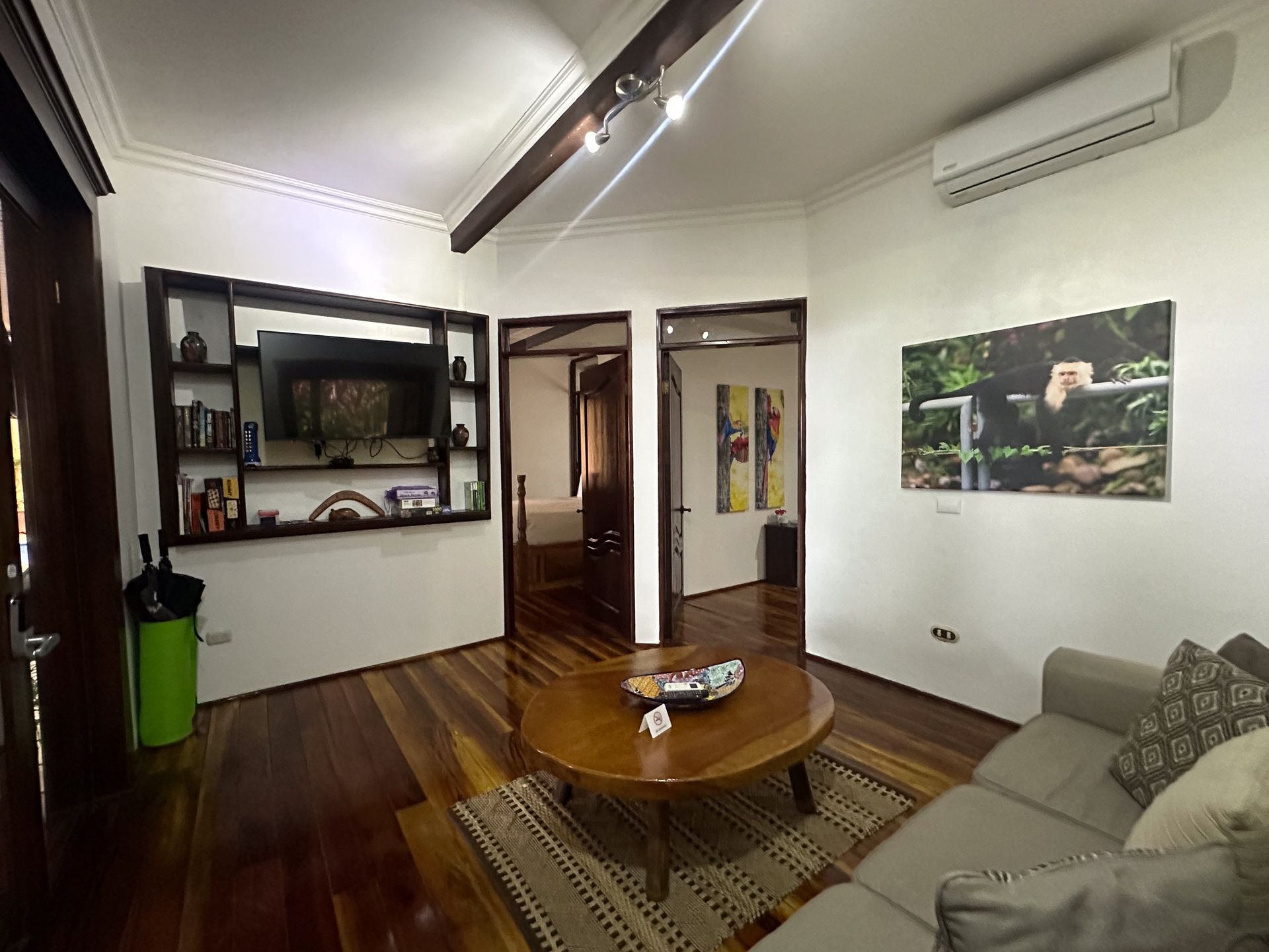 A living room with a couch , coffee table , and television.