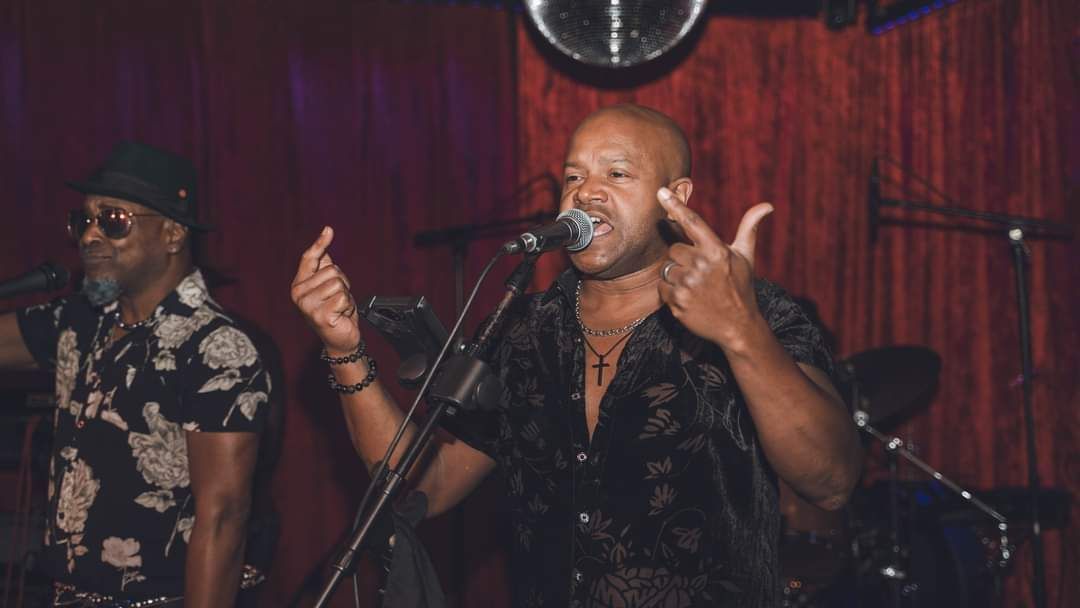 Live band performing on a club stage with professional production