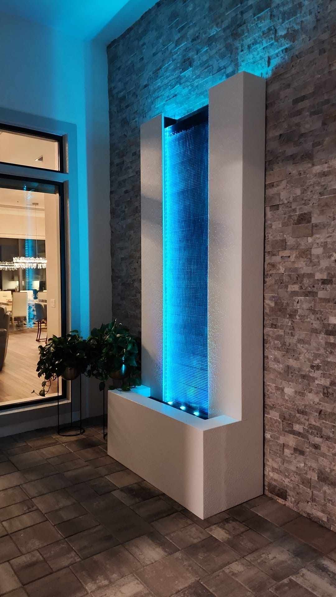 A modern outdoor fountain with blue LED lighting