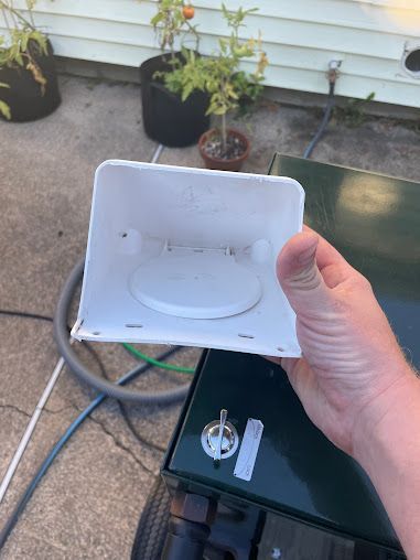 A person is holding a piece of plastic in their hand.