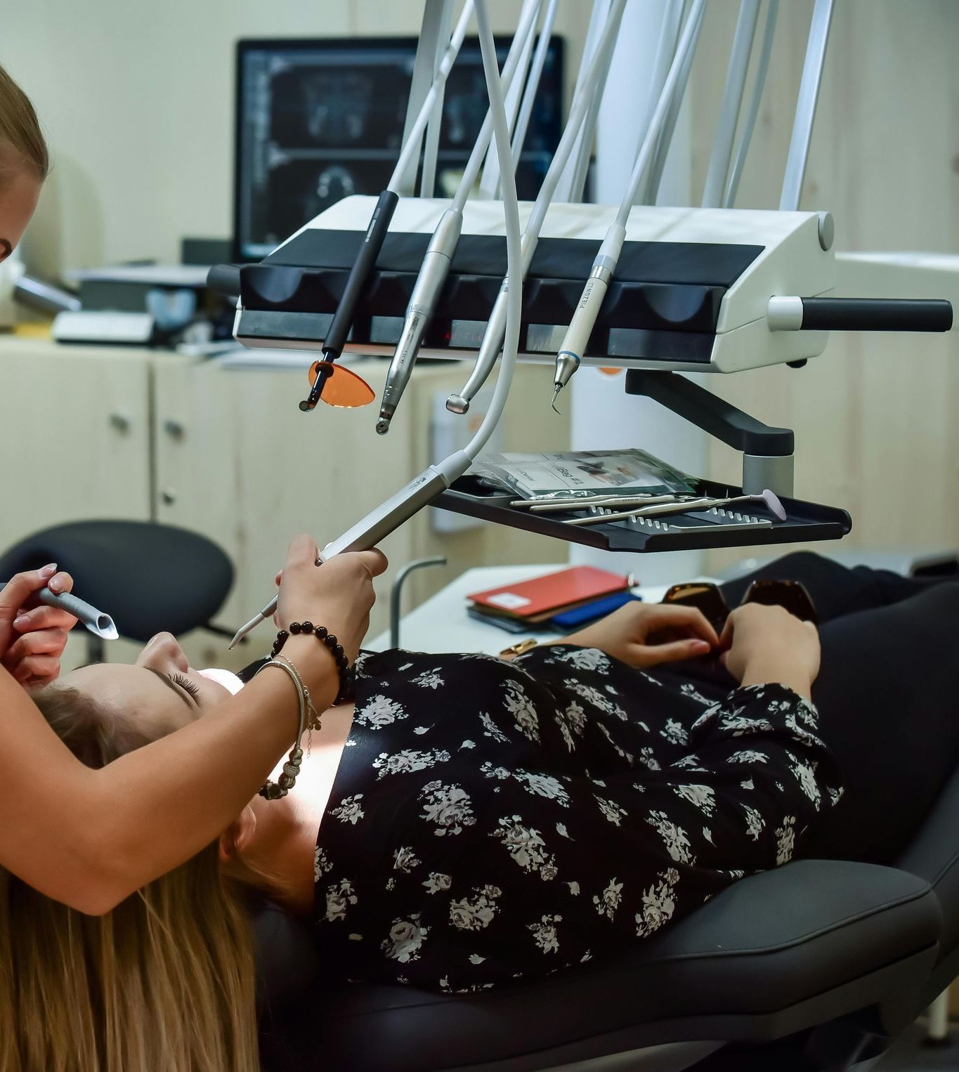 A Woman with Braces Is Brushing Her Teeth with An Interdental Brush — Steve King Dental Group in Edmonton, QLD