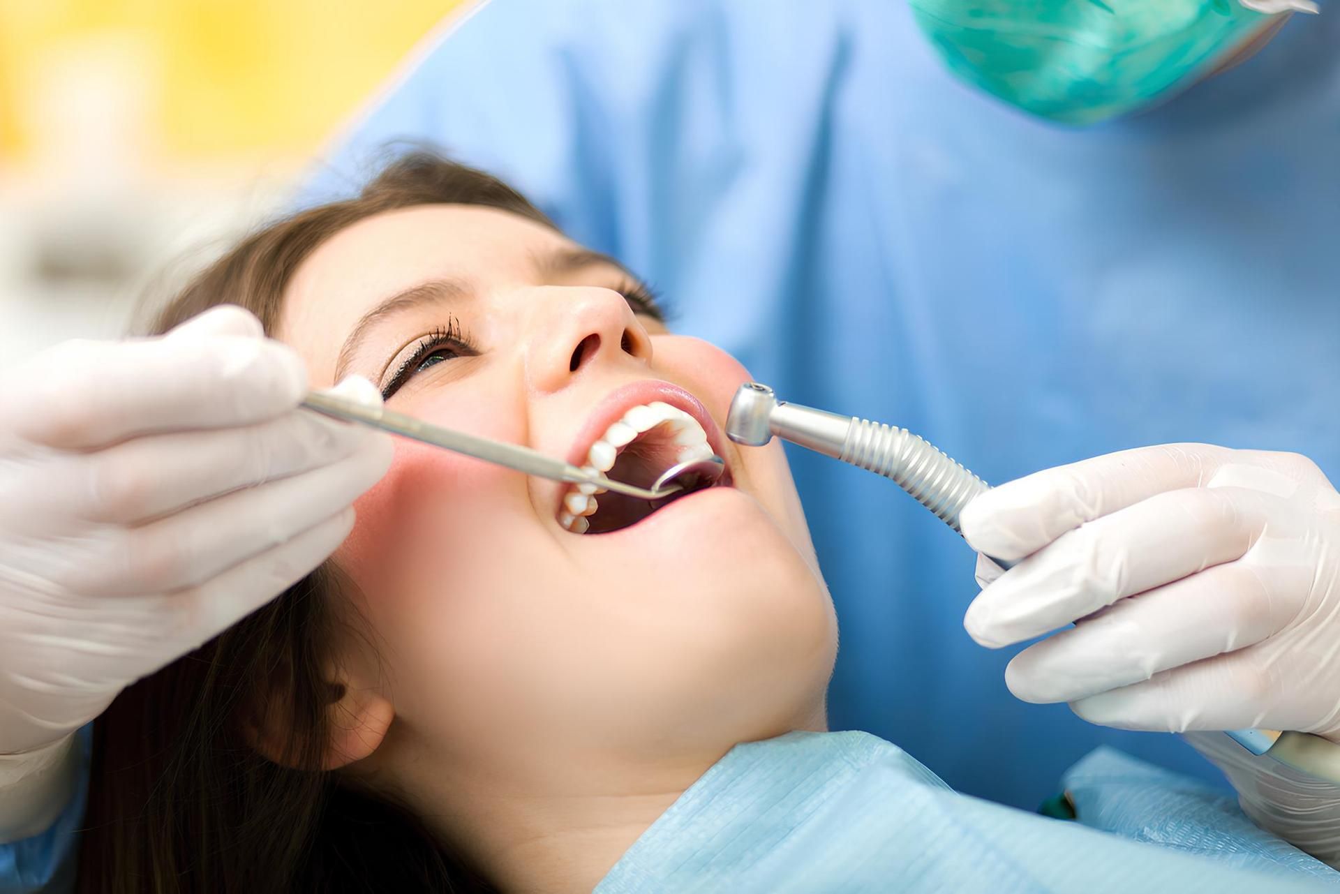 A Woman Is Getting Her Teeth Examined by A Dentist — Steve King Dental Group in Mossman, QLD