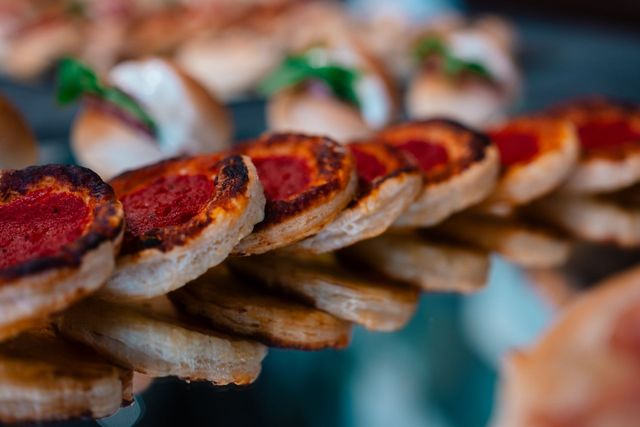 Spiedini di carne grigliata con glassa rossa bruciacchiata, impilati in fila