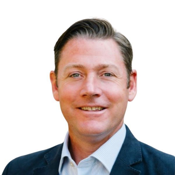 Headshot of a smiling man in a dark blazer and light blue shirt against a white background