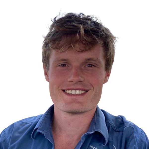 Smiling person in a blue shirt against a white background