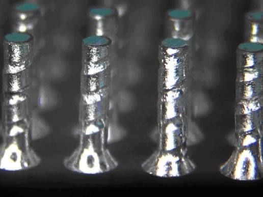 Assorted square computer microchips on a blue background, shown in metallic gray and green