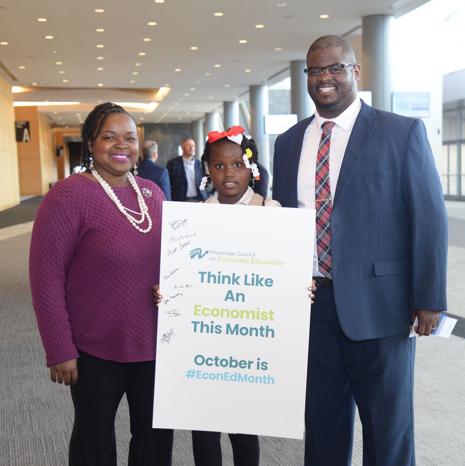 Family holding a sign: 
