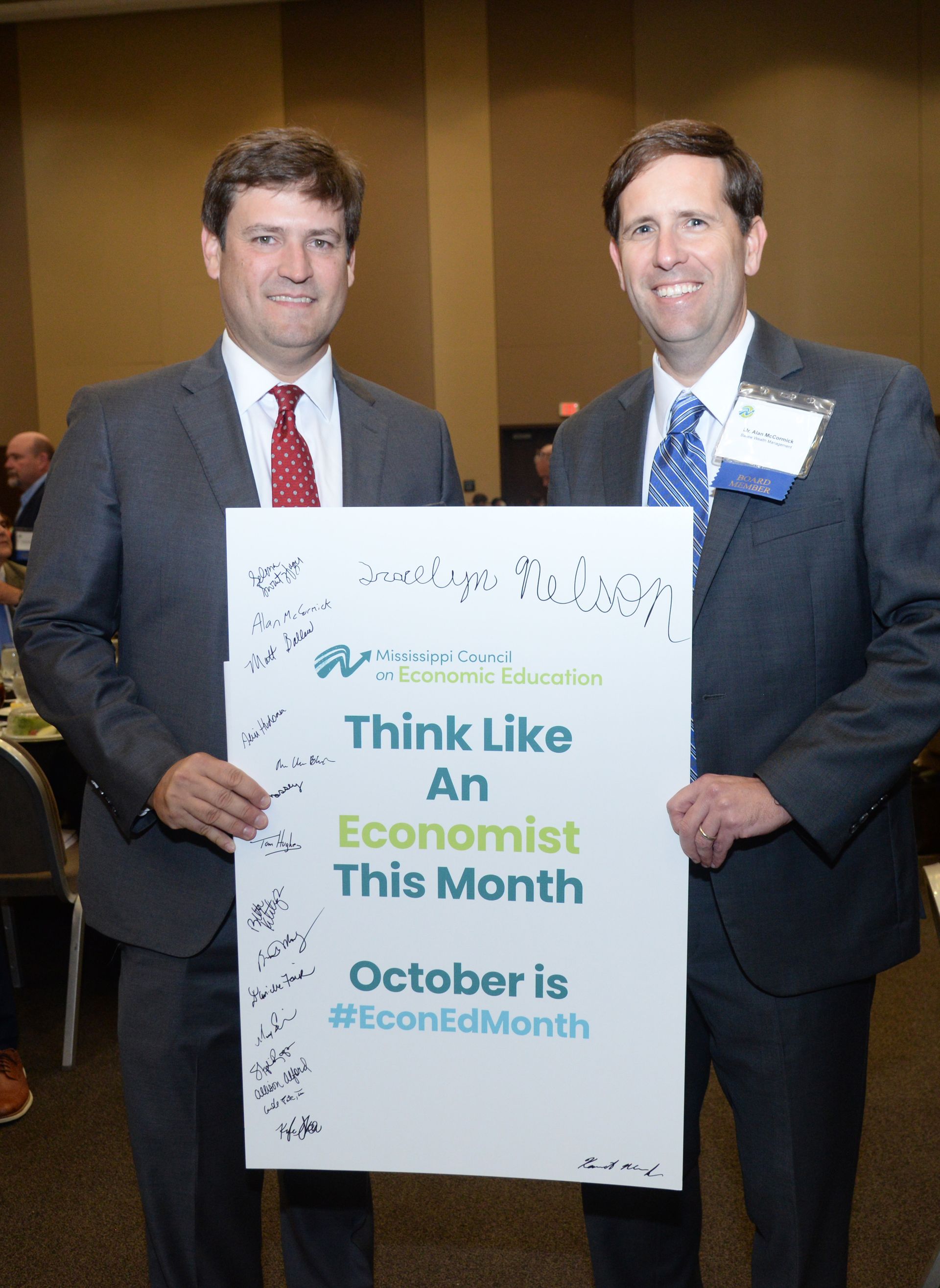 Two men holding a sign that says 