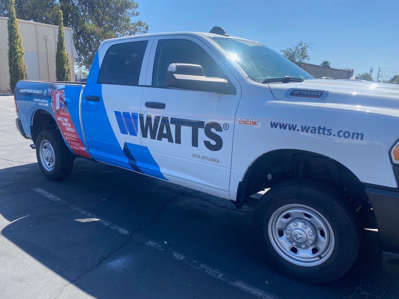 A white pickup truck with blue branded