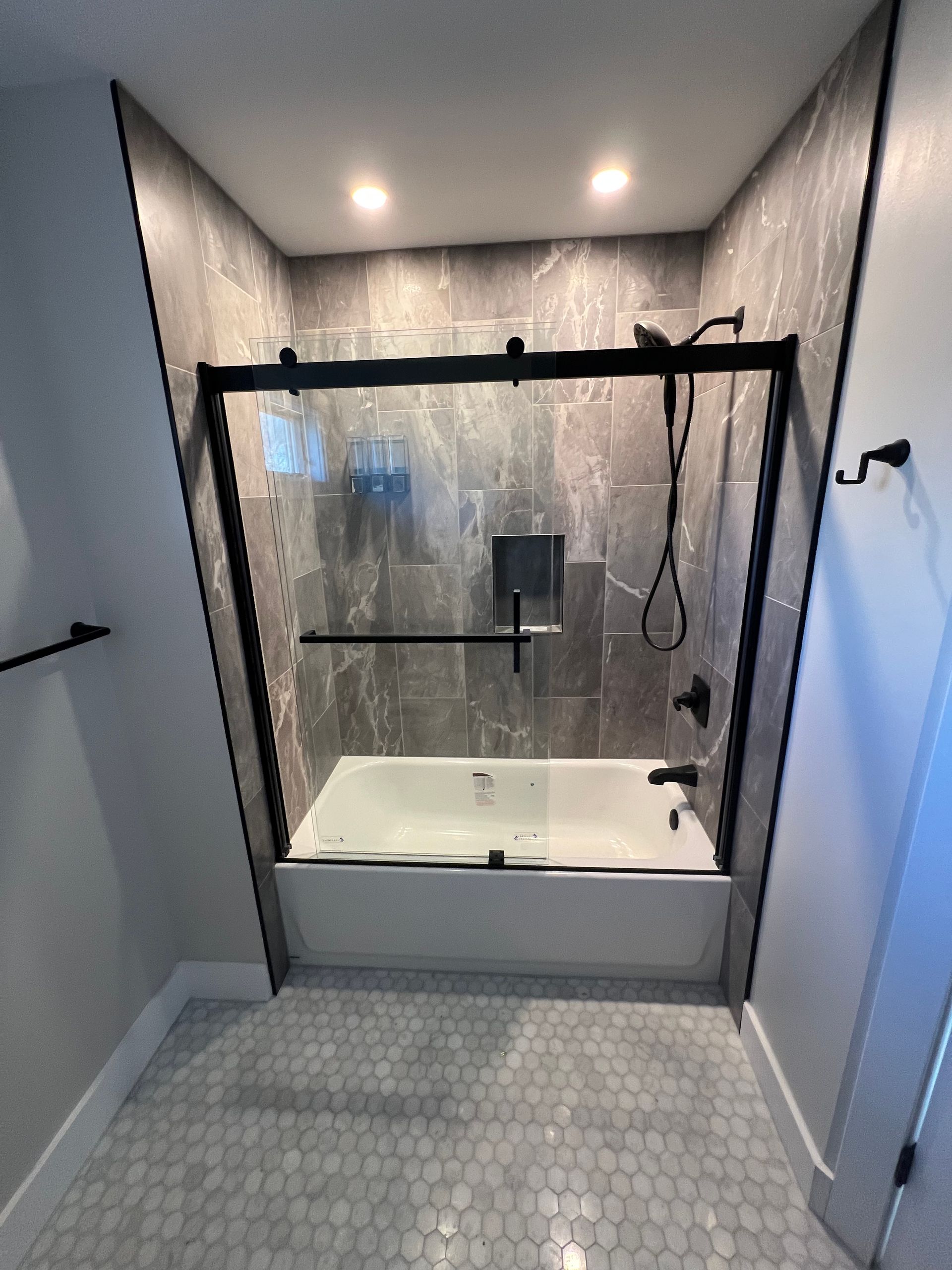 A bathroom with a bathtub and a shower stall.