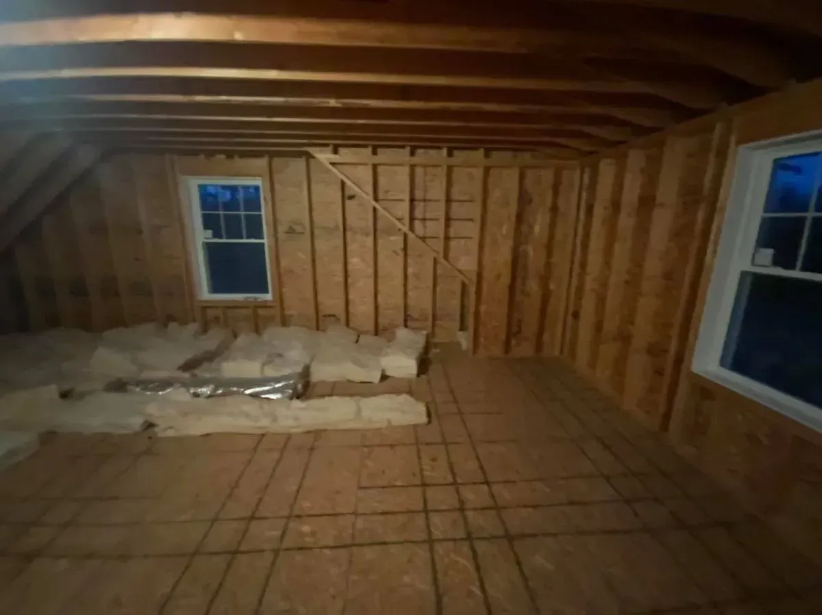 A room with a lot of wooden walls and windows.