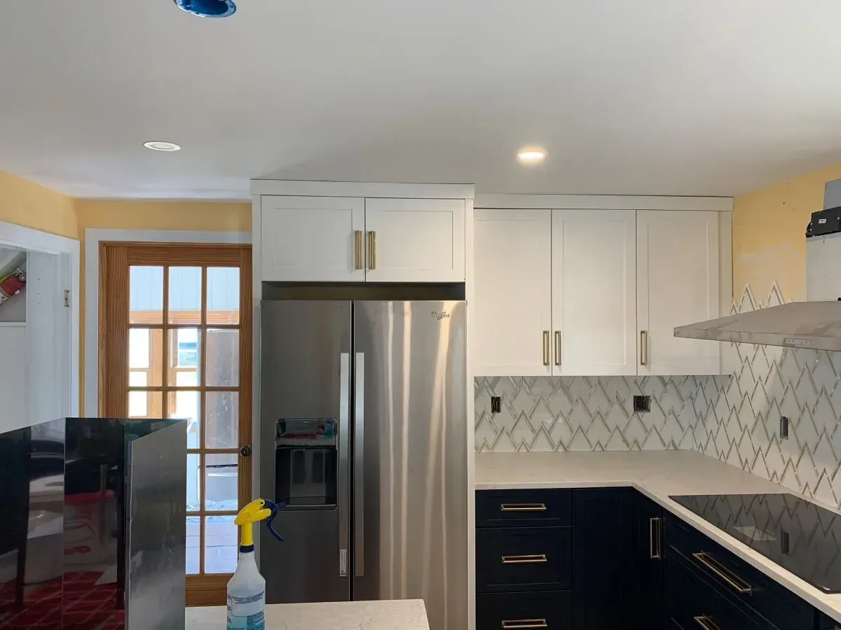 A kitchen with stainless steel appliances and white cabinets