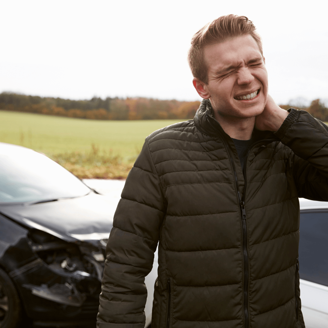 Man holding neck after car accident