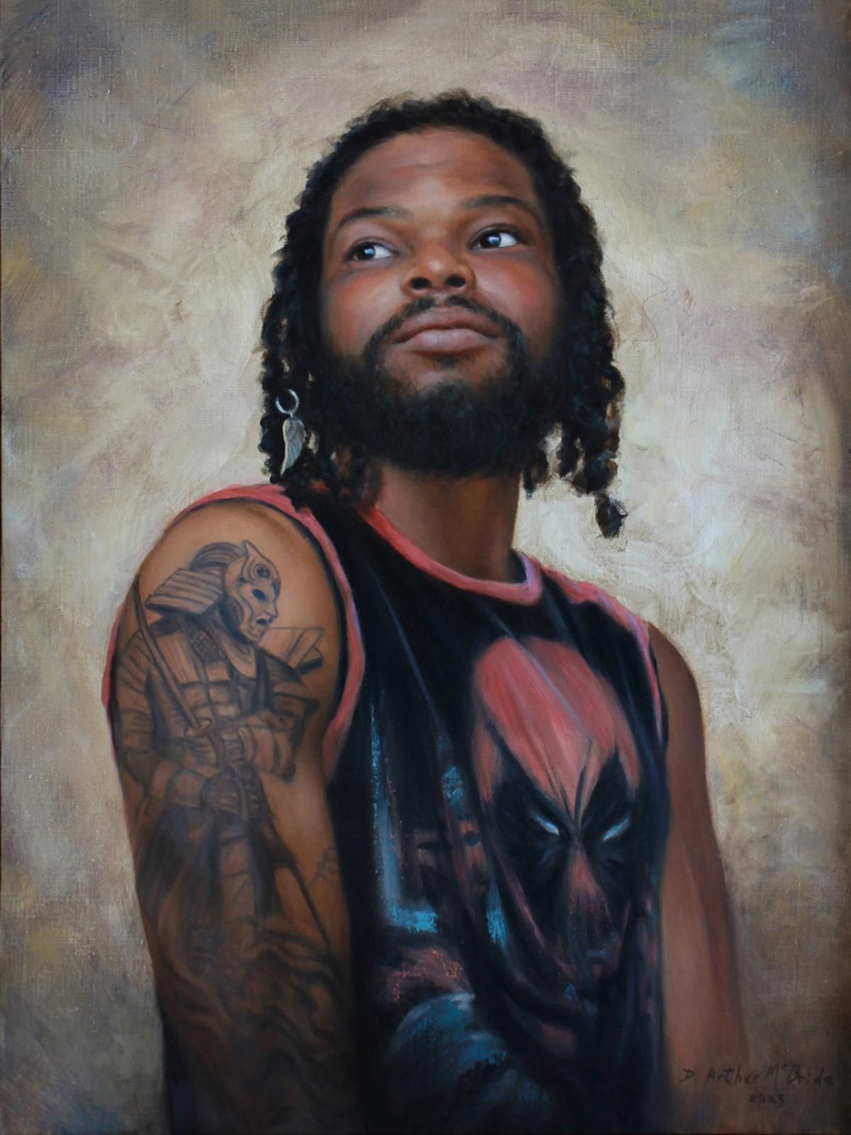 Portrait of a man with shoulder-length hair and beard, wearing a black graphic tank top, against a soft backdrop