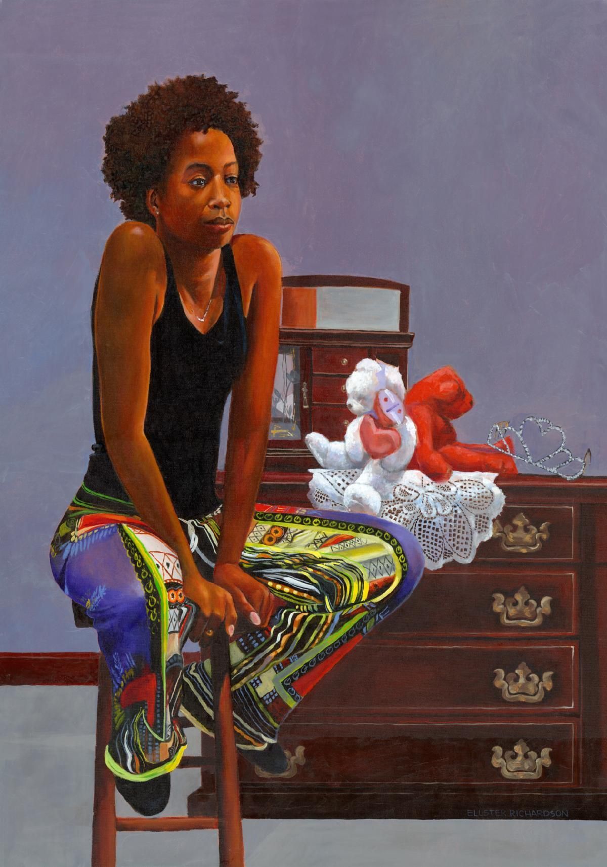 Woman seated on a chair beside a dresser with a white-and-red teddy bear