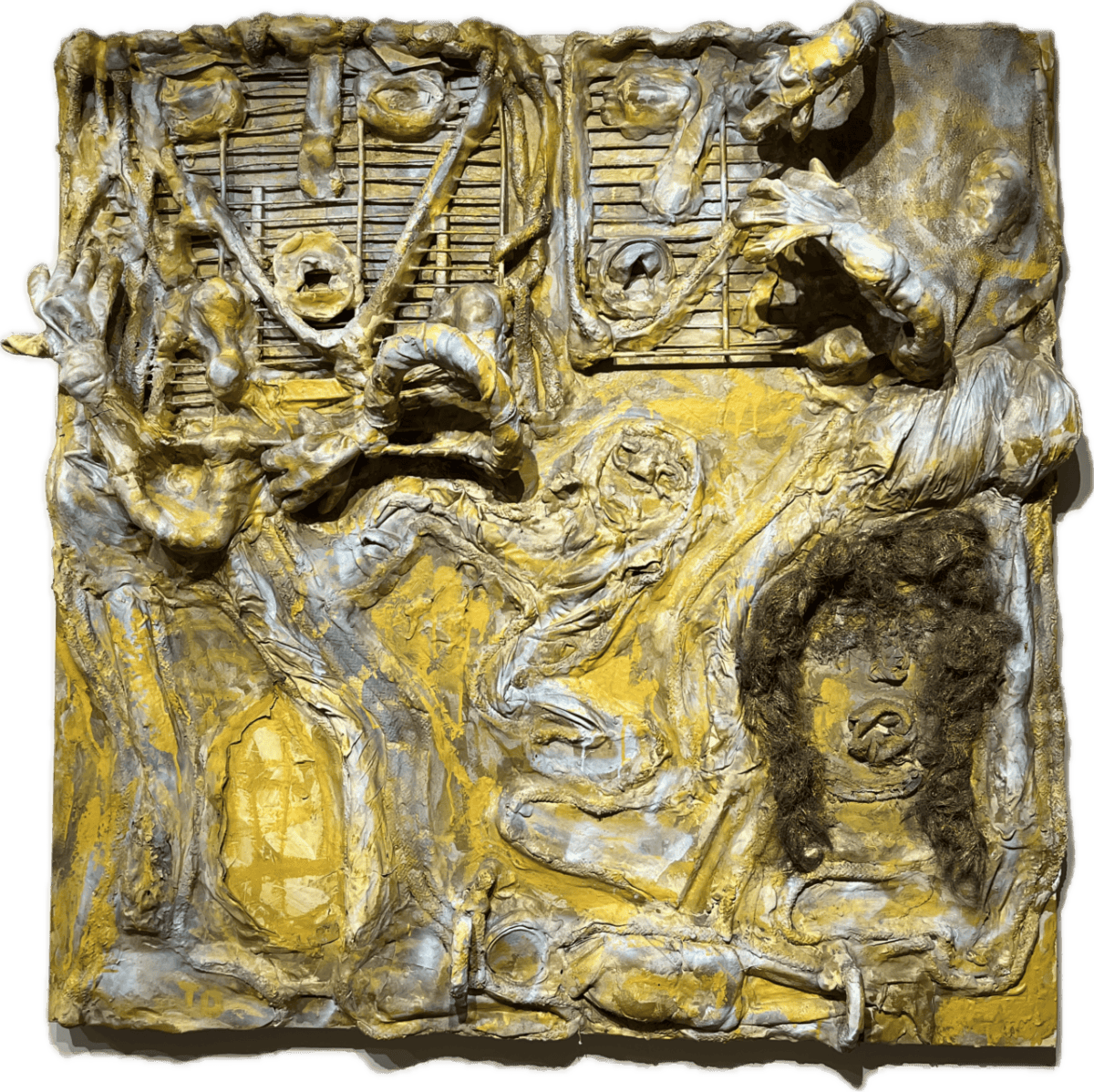 Abstract yellow-gray textured relief with geometric shapes and a central facelike form