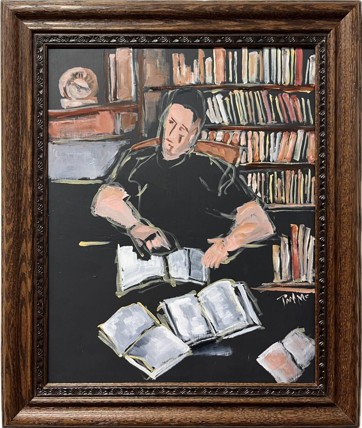 Man reading in a library, surrounded by bookshelves and open books on a table.