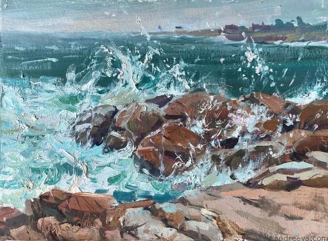 Waves crashing over rocks on a teal sea, with a sandy shore in the foreground.