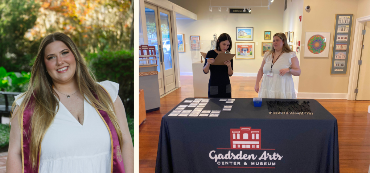 Portrait next to booth display at an art gallery reception, with two women behind a table displaying materials
