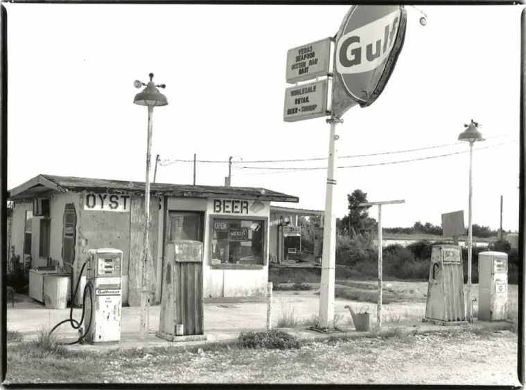 Old roadside beer stand with Gulf sign, pumps, and utility poles in a rural setting