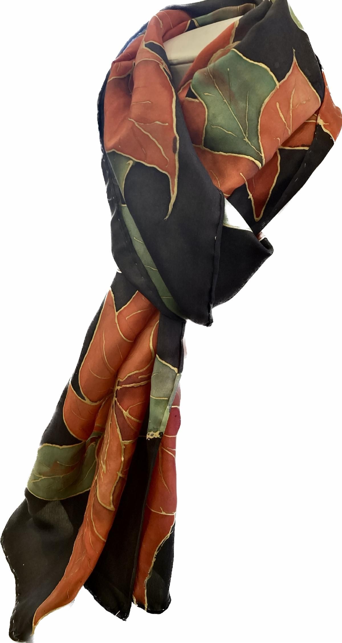 Colorful patterned scarf with black, orange, and green patchwork, tied in a loose knot