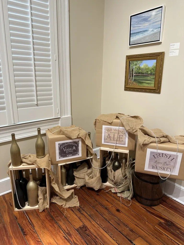 Bags and bottles arranged like a rustic display beside a window in a corner of a room
