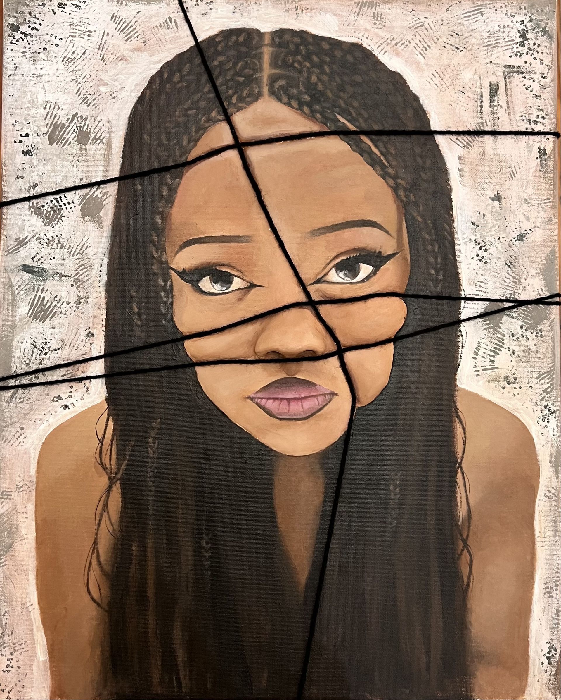 Cracked mural of a woman’s face with long dark hair on a weathered wall.