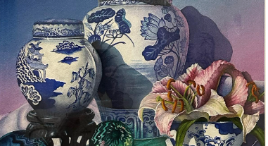 Blue-and-white porcelain vases with flowers and leaves on a soft pink-purple background