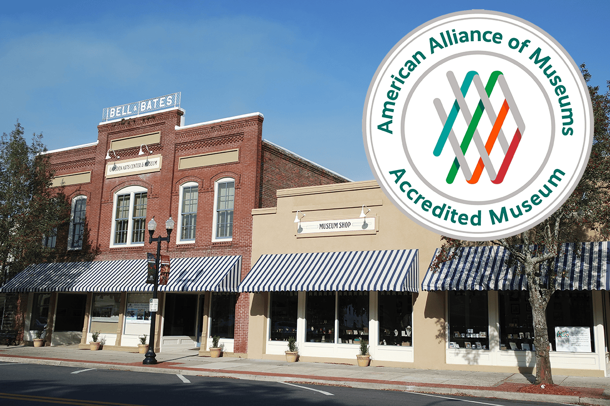 Historic brick museum storefront with striped awnings and an American Alliance of Museums accreditation seal