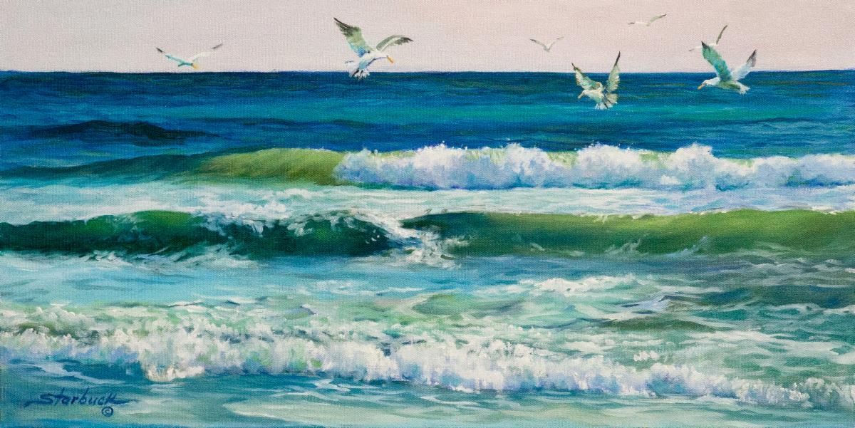 Waves crashing on a blue-green ocean under a bright sky, with a bird flying above.