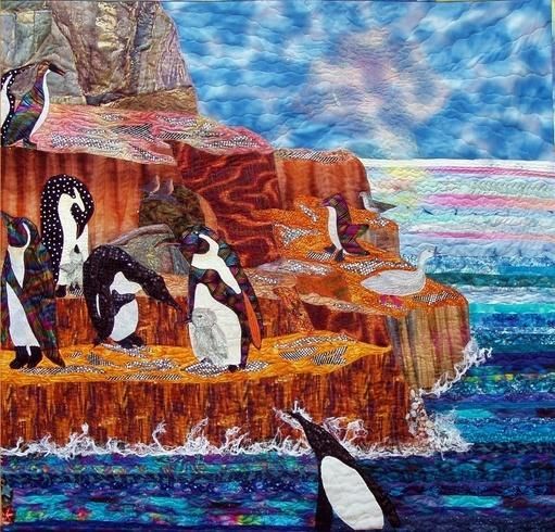 Penguins standing on rocky cliffs by the ocean under a cloudy sky