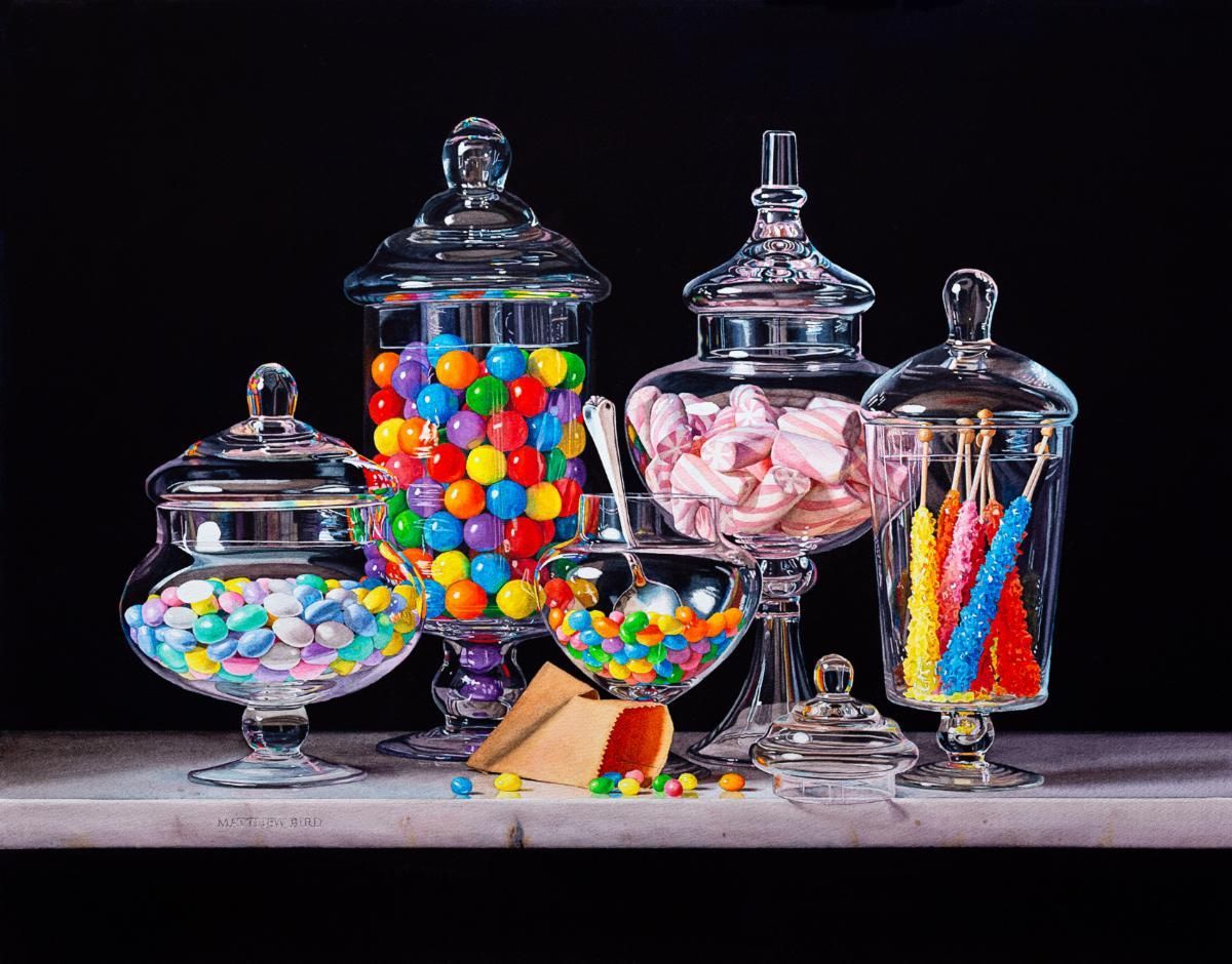 Glass candy jars filled with colorful sweets on a table, including gumballs, marshmallows, and lollipops