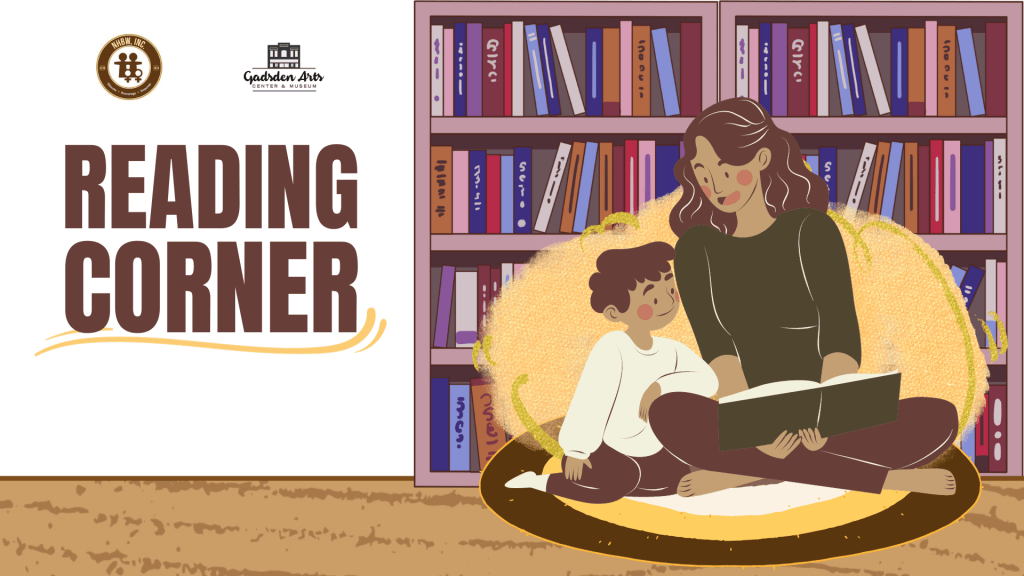Two people reading together in a cozy library corner beside bookshelves and a “READING CORNER” sign