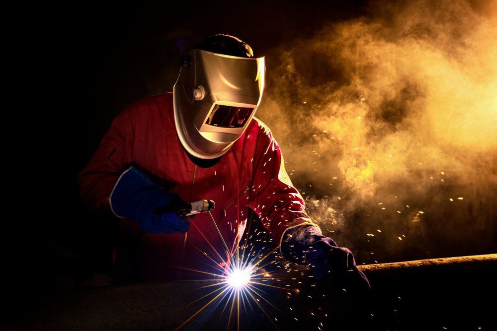 A Man Wearing a Welding Helmet Is Welding a Piece of Metal — North Coast Steel in South West Rocks, NSW
