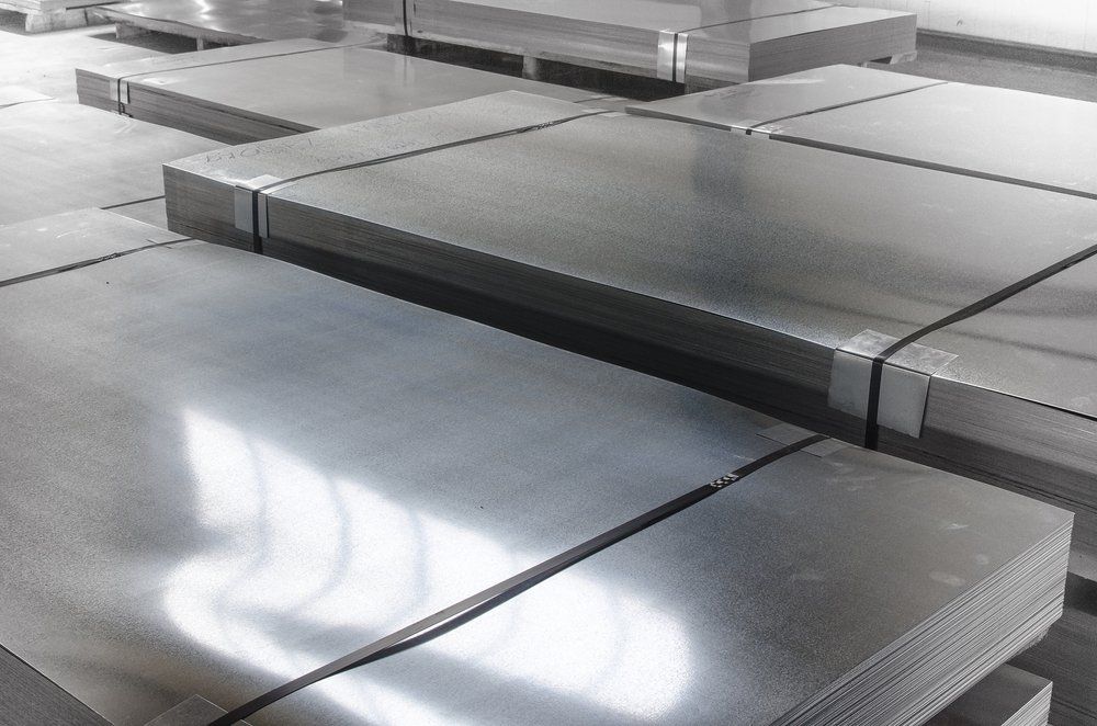 A Bunch of Metal Sheets Are Stacked on Top of Each Other in A Warehouse — North Coast Steel in Port Macquarie, NSW
