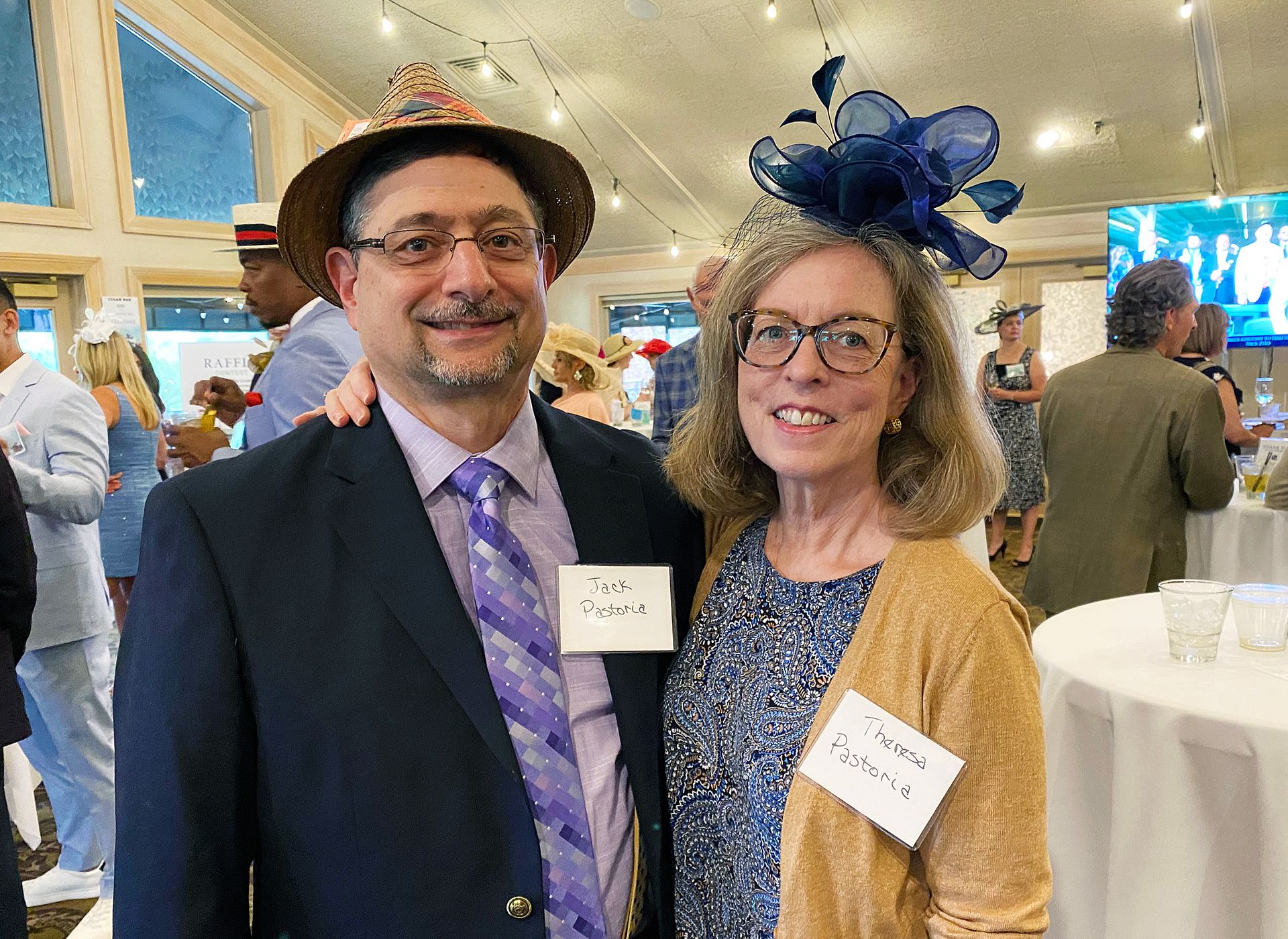 A man and a woman are posing for a picture at a party.