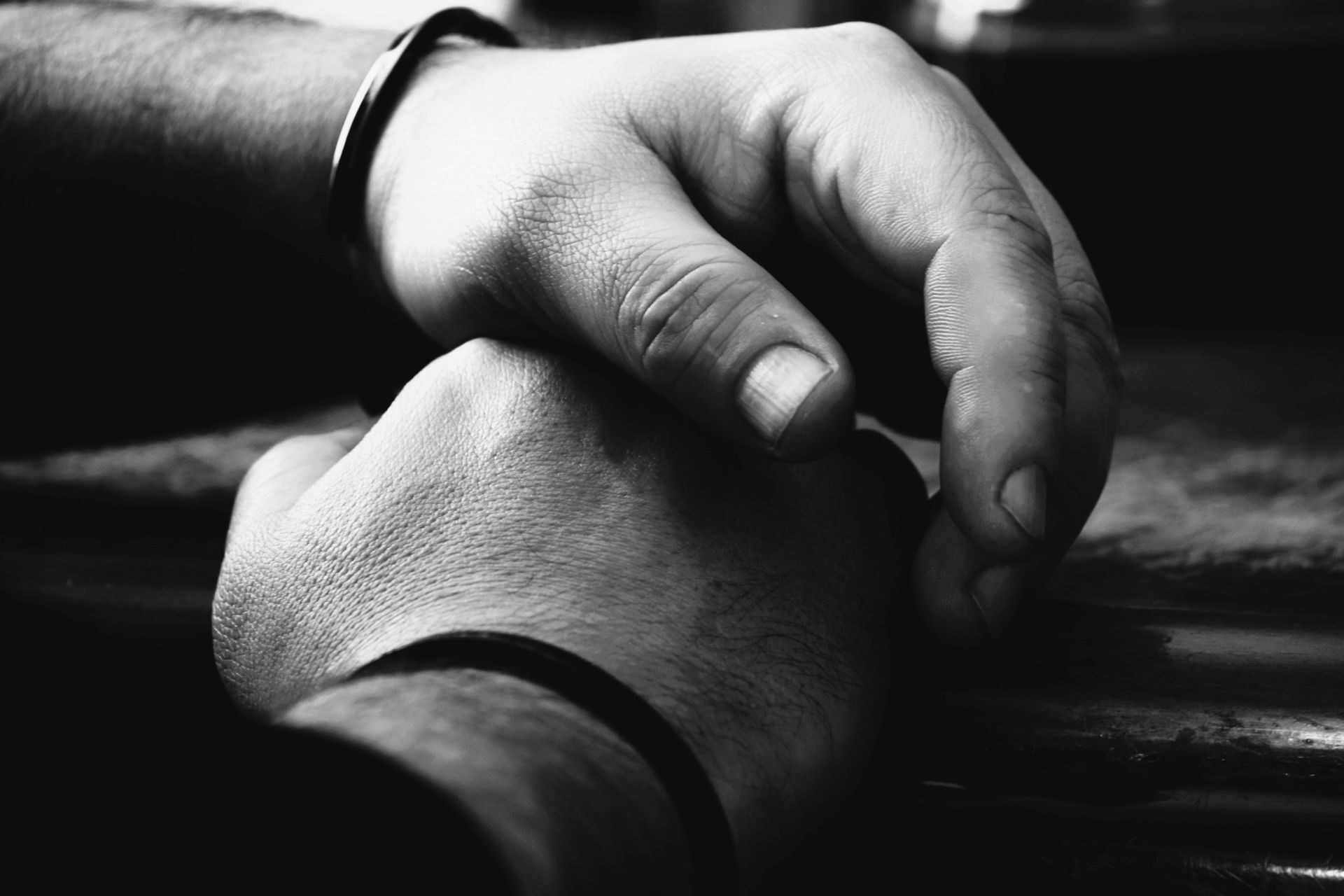 Two hands in a black-and-white close-up