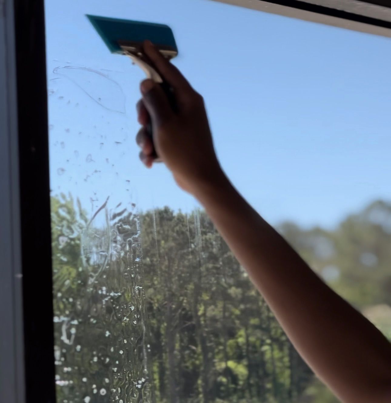 Paint Protection Film - a person is cleaning a helmet with a blue brush.