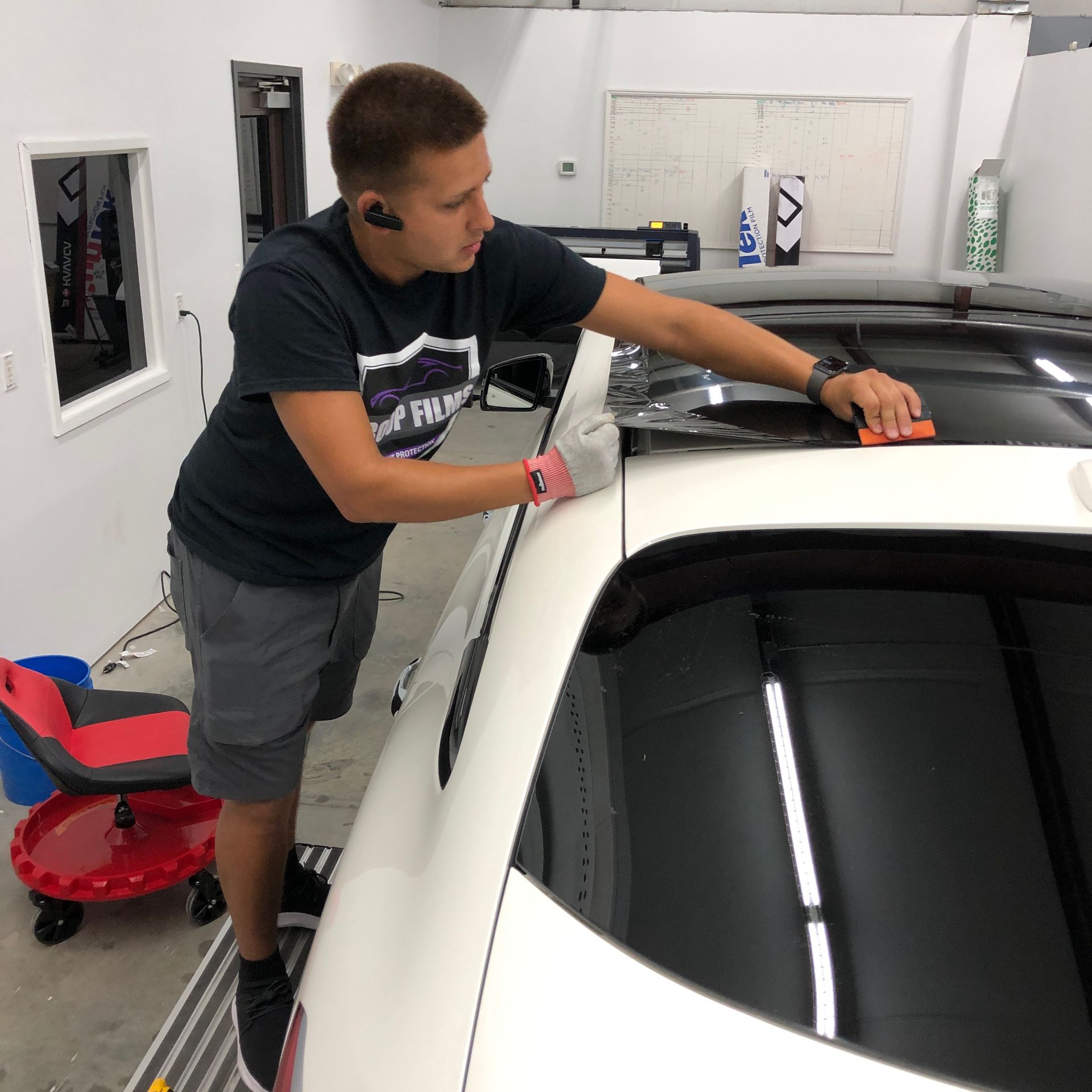 a man is working on the roof of a car
