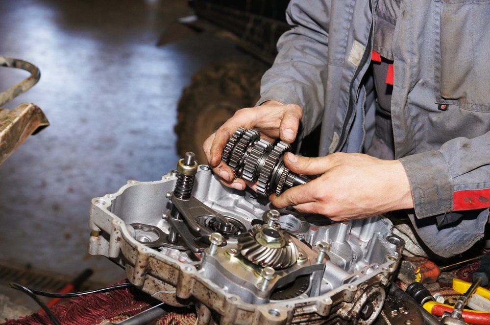 Mechanic Dismantling Boat Engine — Dyna Automotive in Paget, QLD