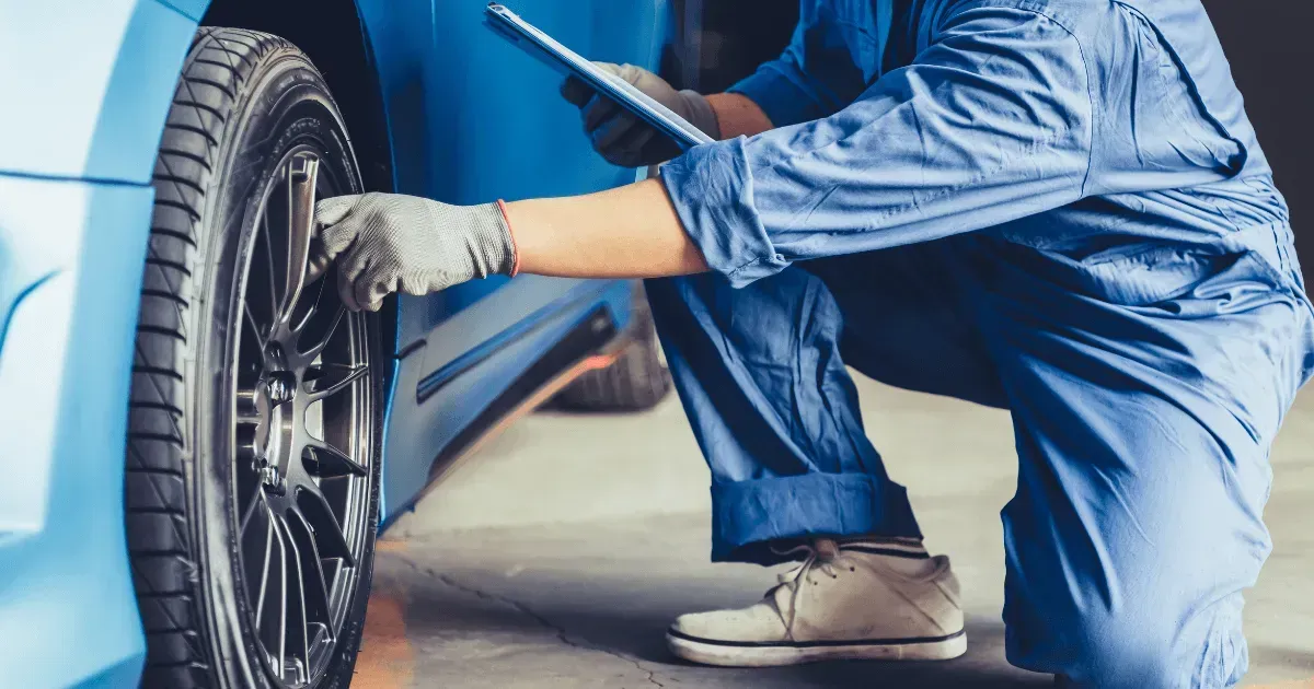 Mechanic checking a car tire and brake system