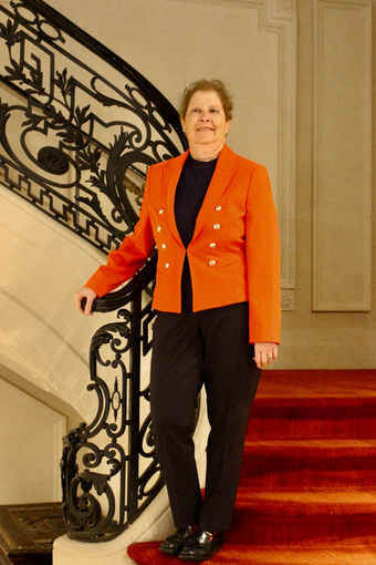 Dr. Leslie Gruis standing on a staircase