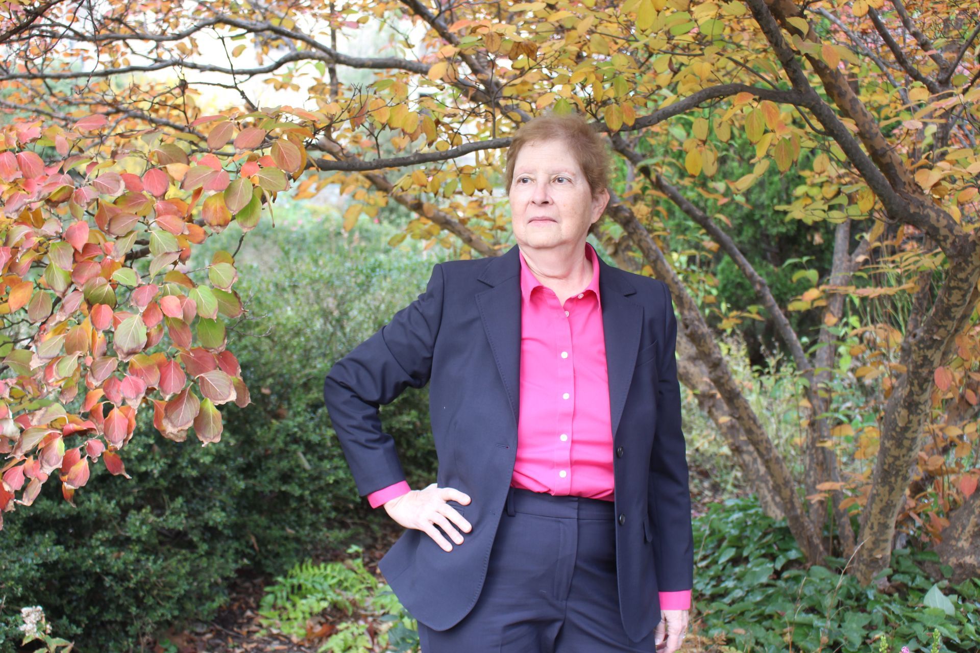 dr. Leslie Gruis in business suit with foliage in the background